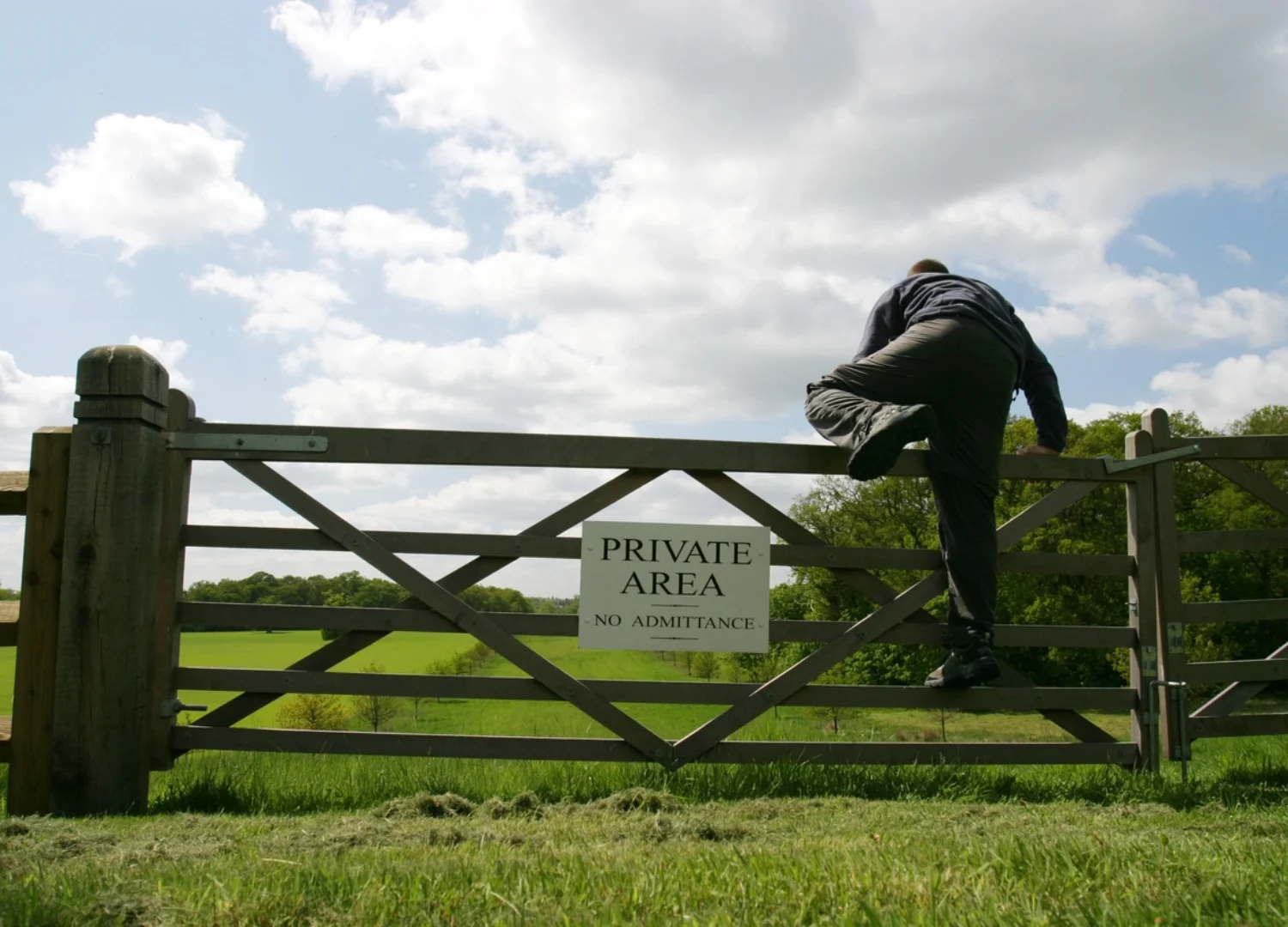 Man jumping over fence. How to Prevent Poaching on Your Estate.